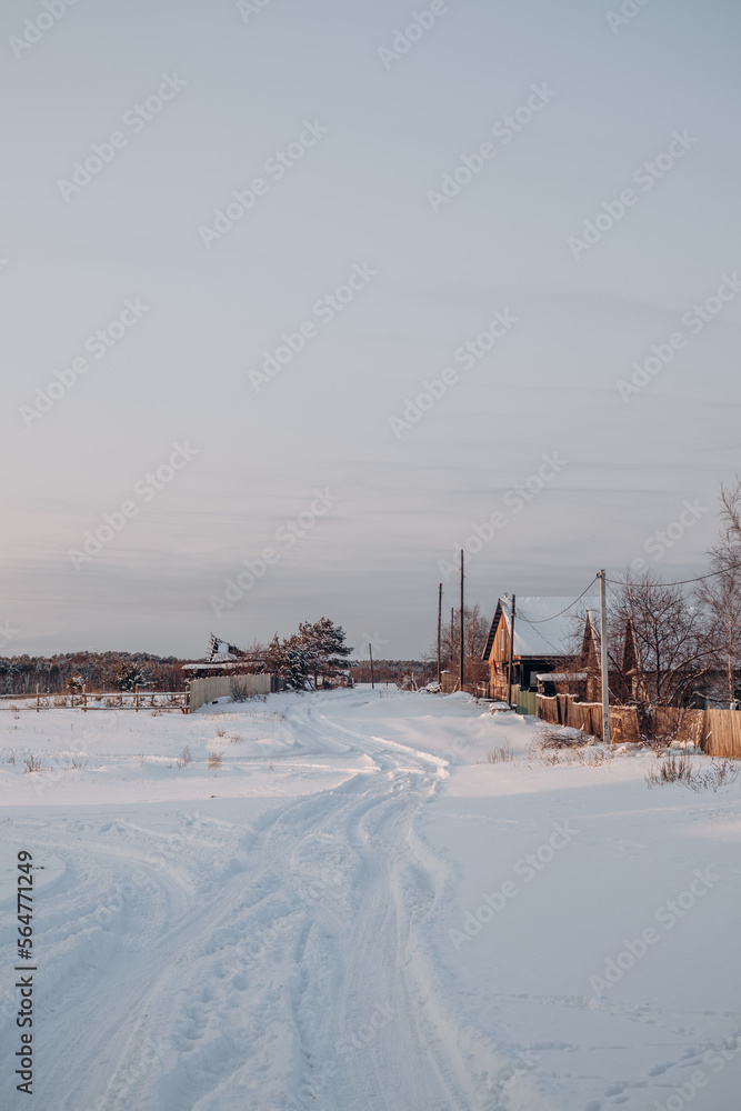 Snow-covered village streets and wooden