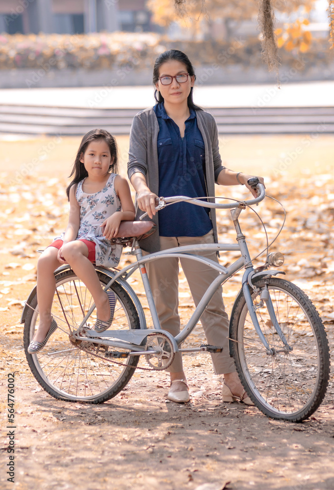 Mother and daughter with flat tires bicycle Mother and daughter with flat tires bicycle