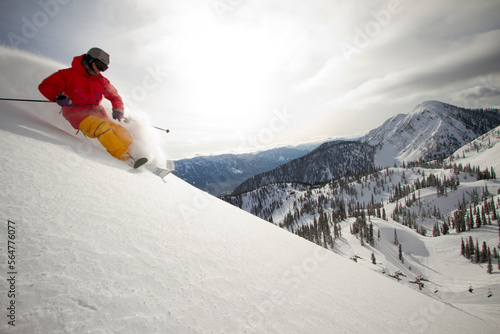 A skier rips a powdery turn on a cloudy day