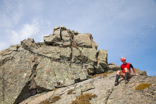 A climber down climbs a rocky summit. photo