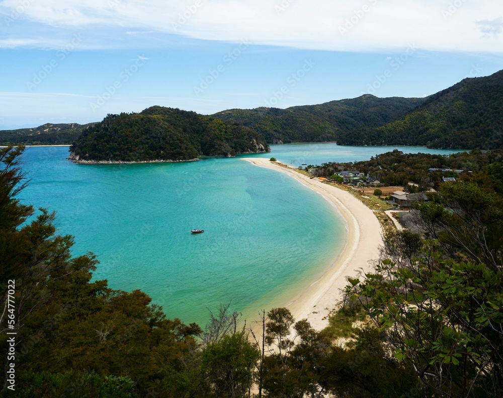 Elevated view of tropical pacific ocean beach surrounded by lush green nature in Abel Tasman National Park New Zealand