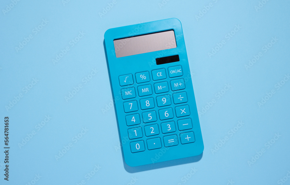 Blue plastic calculator on a blue background, top view Blue plastic calculator on a blue background, top view