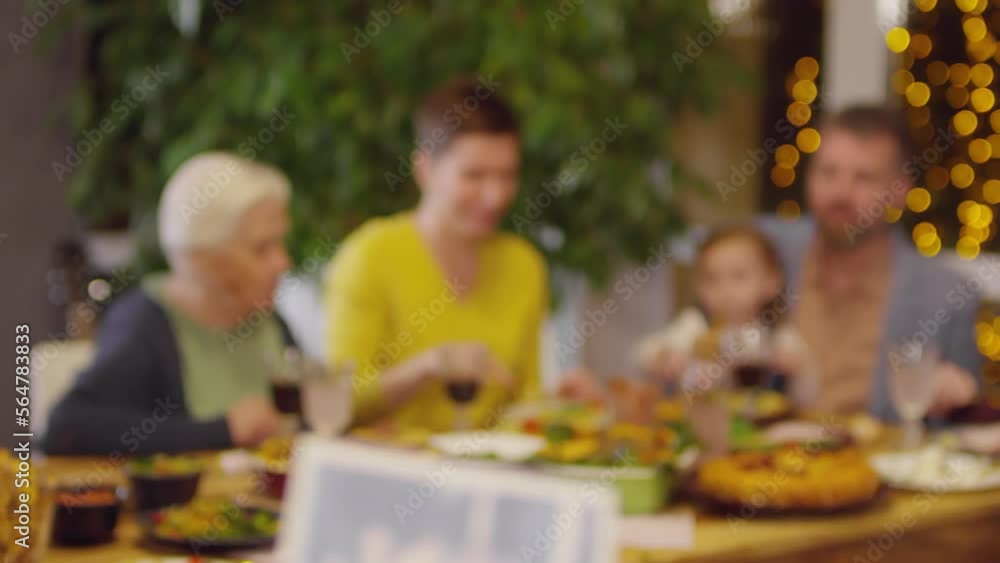 Instant family picture developing while family having festive dinner Instant family picture developing while family having festive dinner