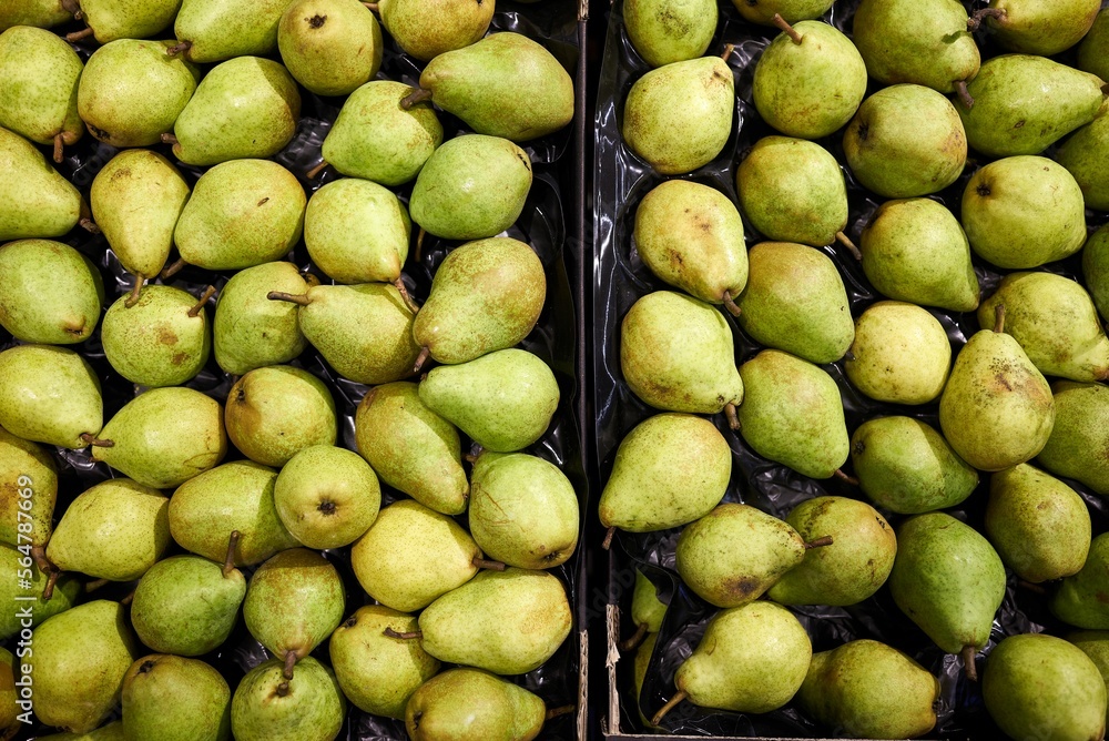 organic pears in a container at a market stall