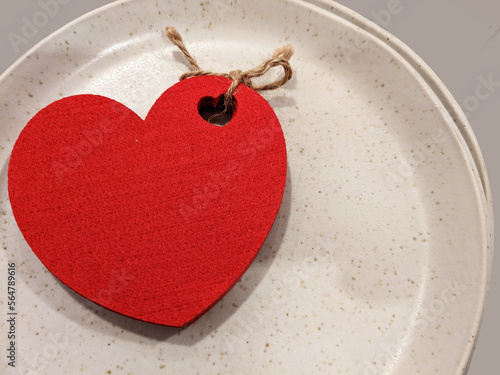 red heart made of wood on a plate