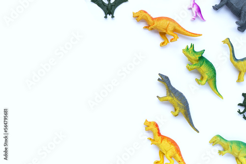 Fototapeta Naklejka Na Ścianę i Meble -  Plastic dinosaur toys on white background. Top view