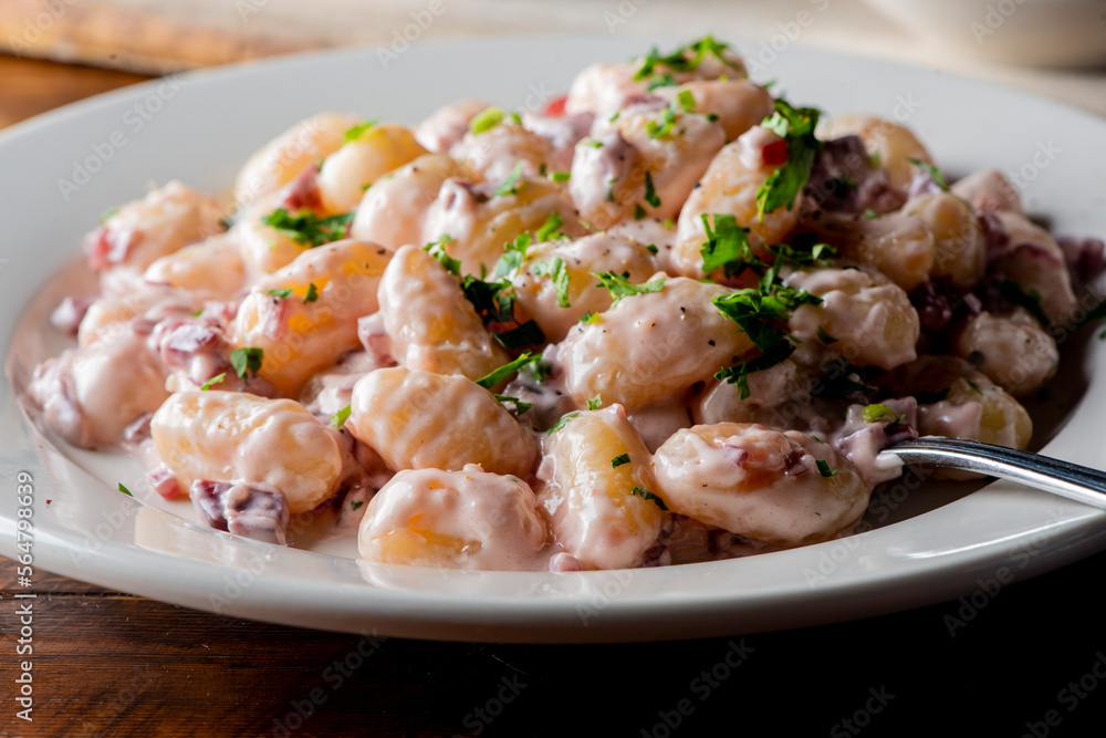 Gnocchi. Pasta sautéed with truffles garlic, onions, olive oil and fresh herbs and spices. Classic American steakhouse or French bistro appetizer or side dish. Gnocchi. Pasta sautéed with truffles garlic, onions, olive oil and fresh herbs and spices. Classic American steakhouse or French bistro appetizer or side dish.