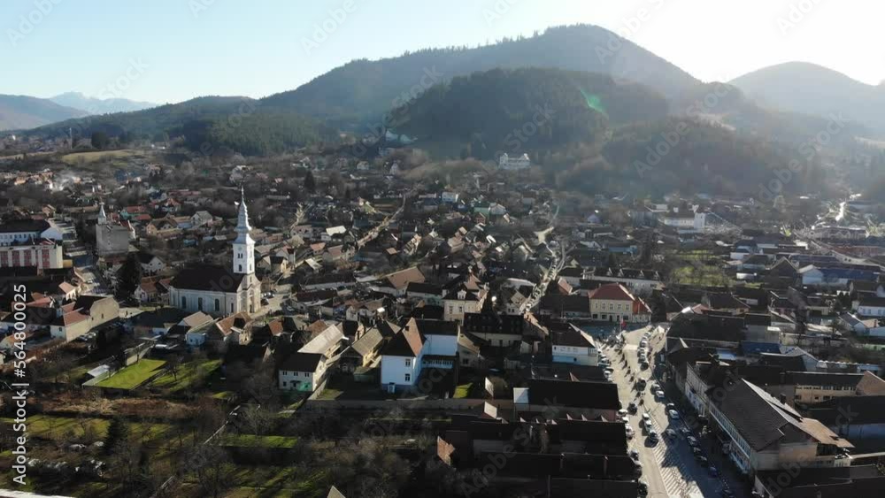 A panning aerial view of Sacele, Brasov city centre on a sunny day A panning aerial view of Sacele, Brasov city centre on a sunny day