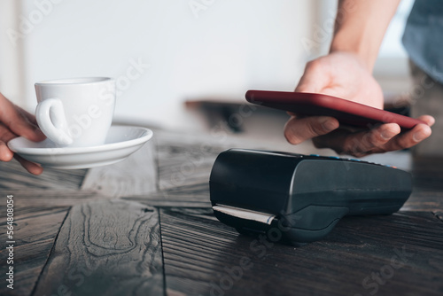 Paying bill through smartphone using NFC technology. photo