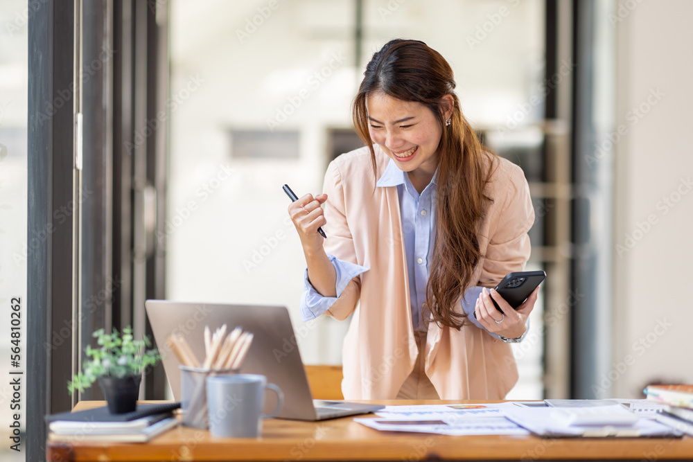 happy excited.Portrait of success business asian woman enjoy success with laptop on work desk. Authentic shot joyful asian girl got jackpot, Surprised and celebrating her victory. happy excited.Portrait of success business asian woman enjoy success with laptop on work desk. Authentic shot joyful asian girl got jackpot, Surprised and celebrating her victory.