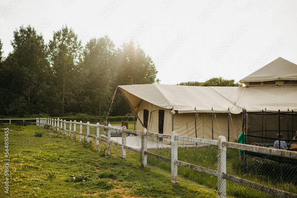 Field with large tent and trampoline Field with large tent and trampoline