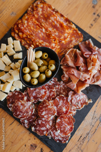 charcuterie board with salami, cheese, olives and ham photo