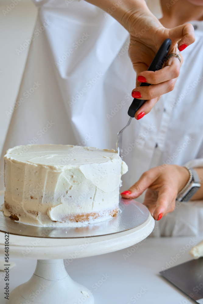 a female pastry chef bakes and decorates a cake a female pastry chef bakes and decorates a cake