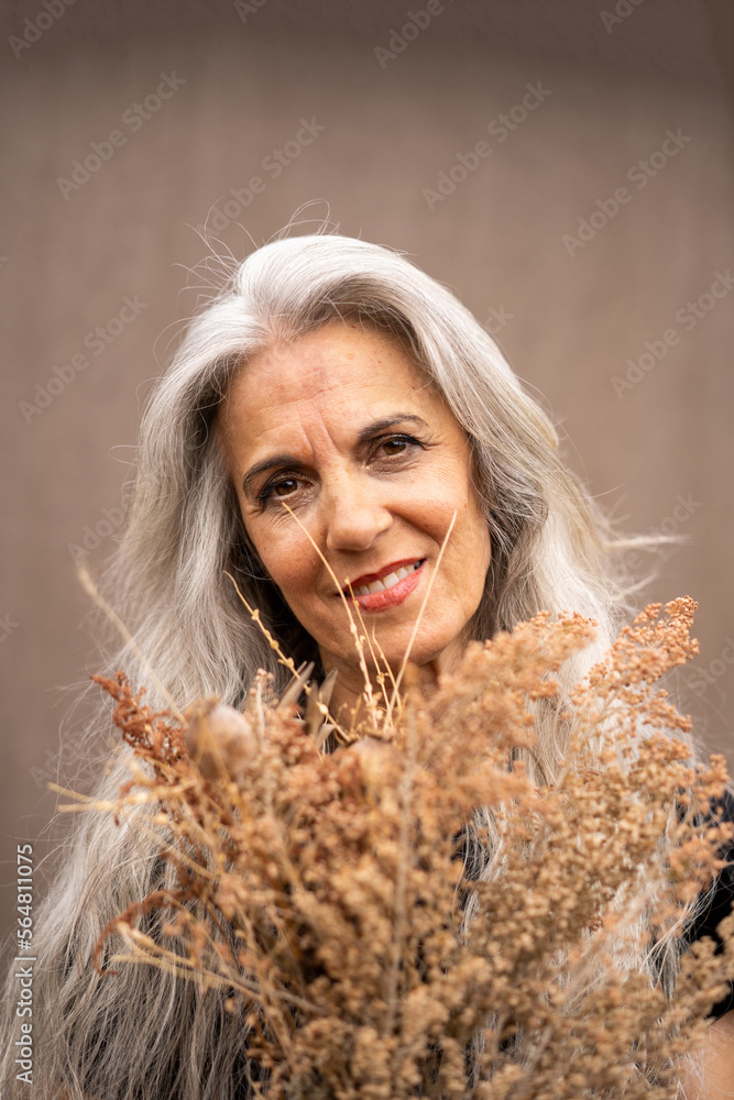 Mature grey hair model portrait with flowers Mature grey hair model portrait with flowers