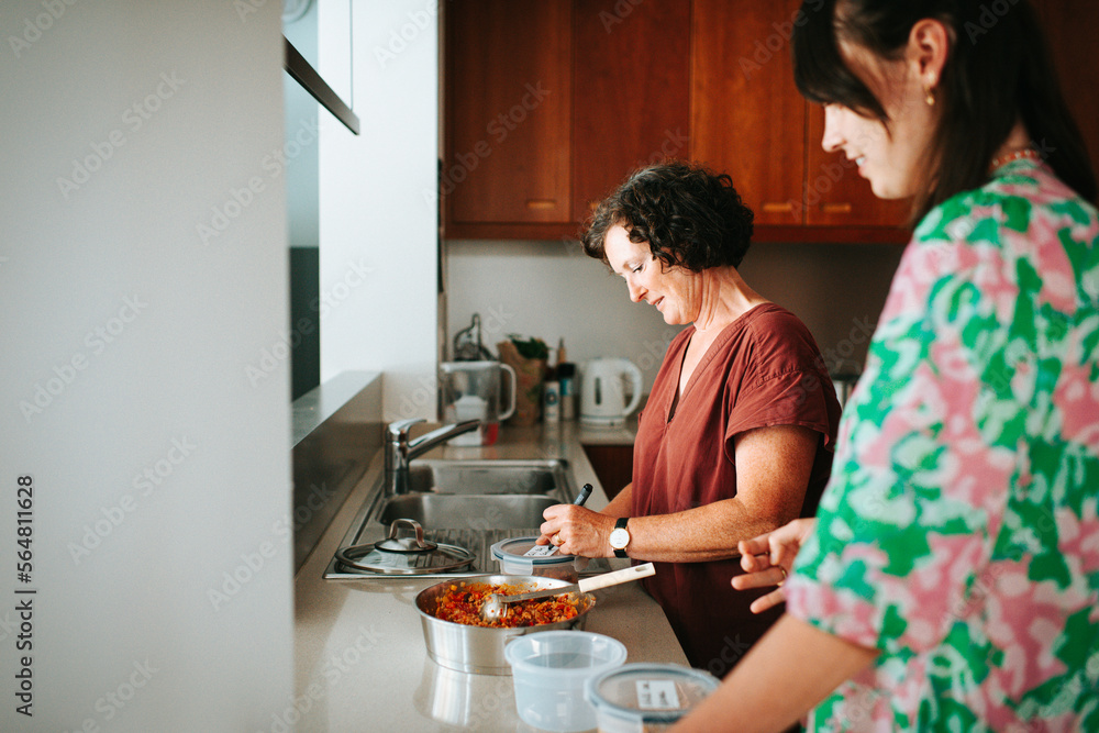 Mother and daughter prepping food in the kitchen Mother and daughter prepping food in the kitchen