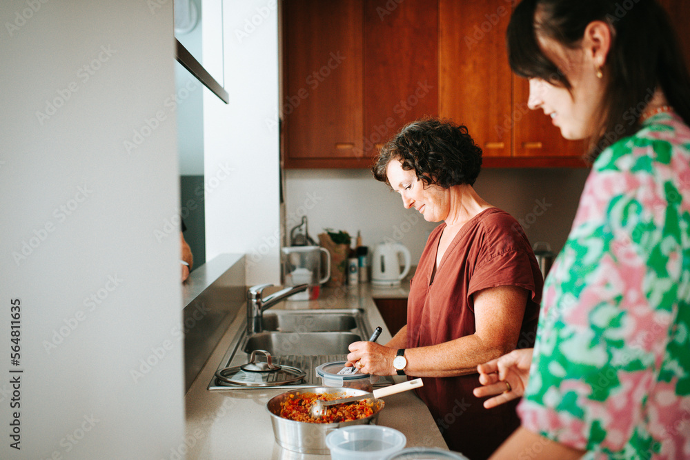 Mother and daughter prepping food in the kitchen Mother and daughter prepping food in the kitchen
