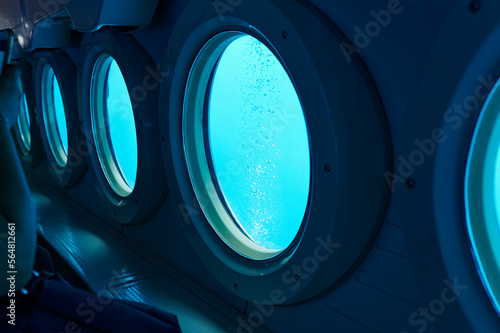 Portholes of a small sub underwater