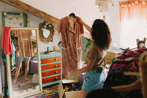 Woman looking to her vintage dress photo