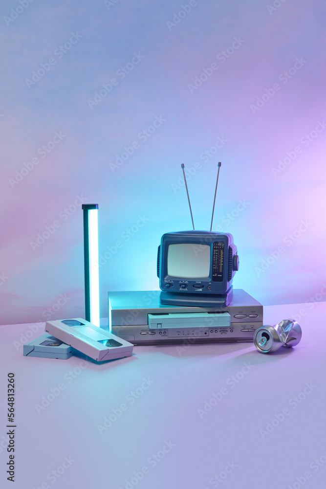 Small TV with VCR player, old VHS cassettes. Stock Photo Adobe Stock