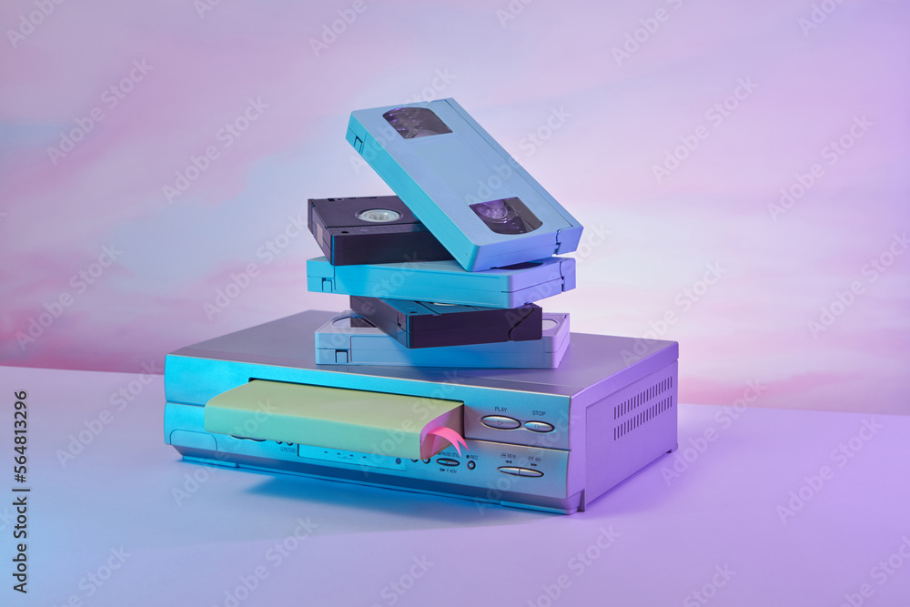 Pile of VHS cassettes on VCR video player. Stock Photo Adobe Stock