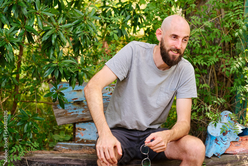 Smiling bearded man on bench. photo