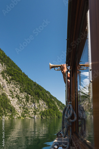 Man playing anthem on a trumpet on a boat photo