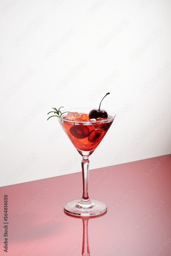 a glasses of pink gin or vodka infused with fresh cherry a glasses of pink gin or vodka infused with fresh cherry