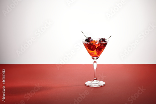 a long-stemmed glass with cherry liqueur or any red alcoholic photo