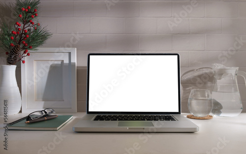 Laptop computer, coffee cup, stationery and potted plant on grey table. Blank screen for your advertise design.