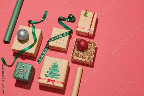 Gift boxes, paper's rools and decorations on color background photo