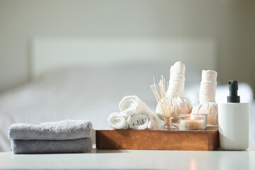 Foto auf Acrylglas Massagesalon Spa treatment concept. Towels, massage oil, spa herbal compress balls and burning candles on table with copy space.  © wattana