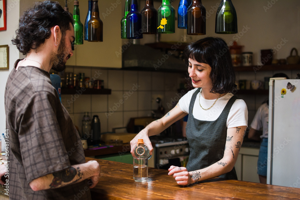 Business owner pouring a glass of water