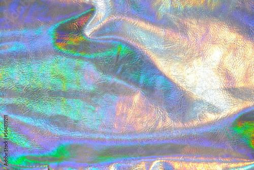 holographic wallpaper In silver, purple and green colors.metallic fabric with iridescent gradients. metal holographic material. texture with iridescent waves and folds.