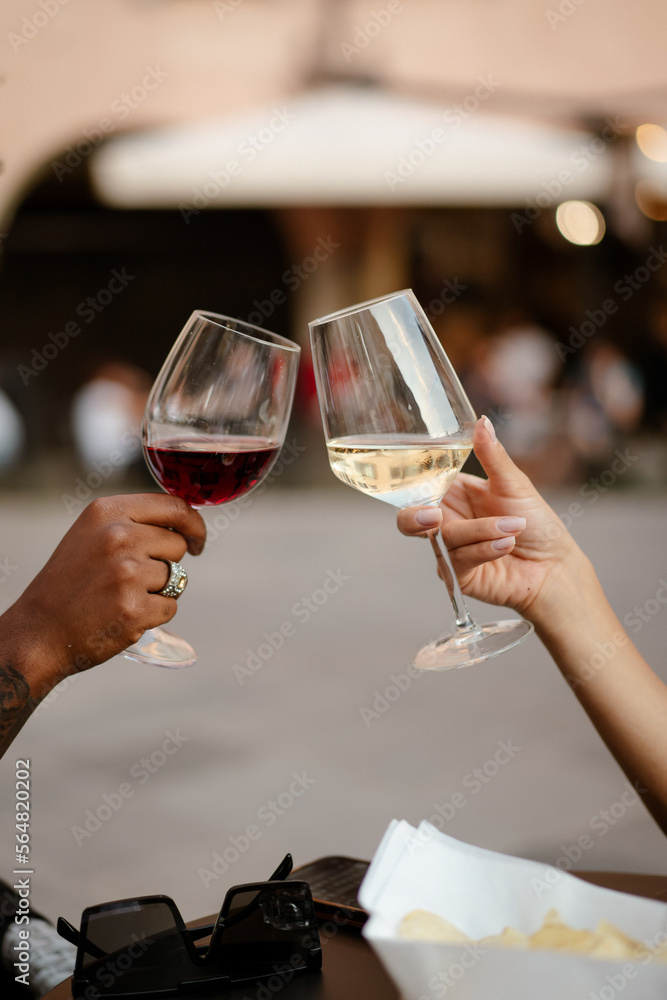Two anonymous people make a toast at the bar Two anonymous people make a toast at the bar