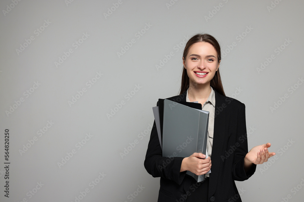 Portrait of beautiful young teacher on grey background. Space for text Portrait of beautiful young teacher on grey background. Space for text