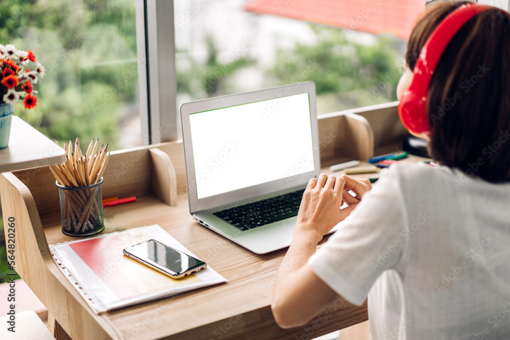 Young creative woman relaxing using laptop computer working and typing on keyboard with white mockup blank screens at home Young creative woman relaxing using laptop computer working and typing on keyboard with white mockup blank screens at home