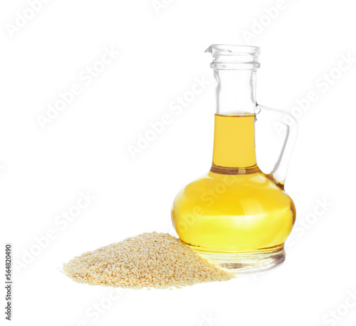 Glass jug of fresh sesame oil and seeds isolated on white