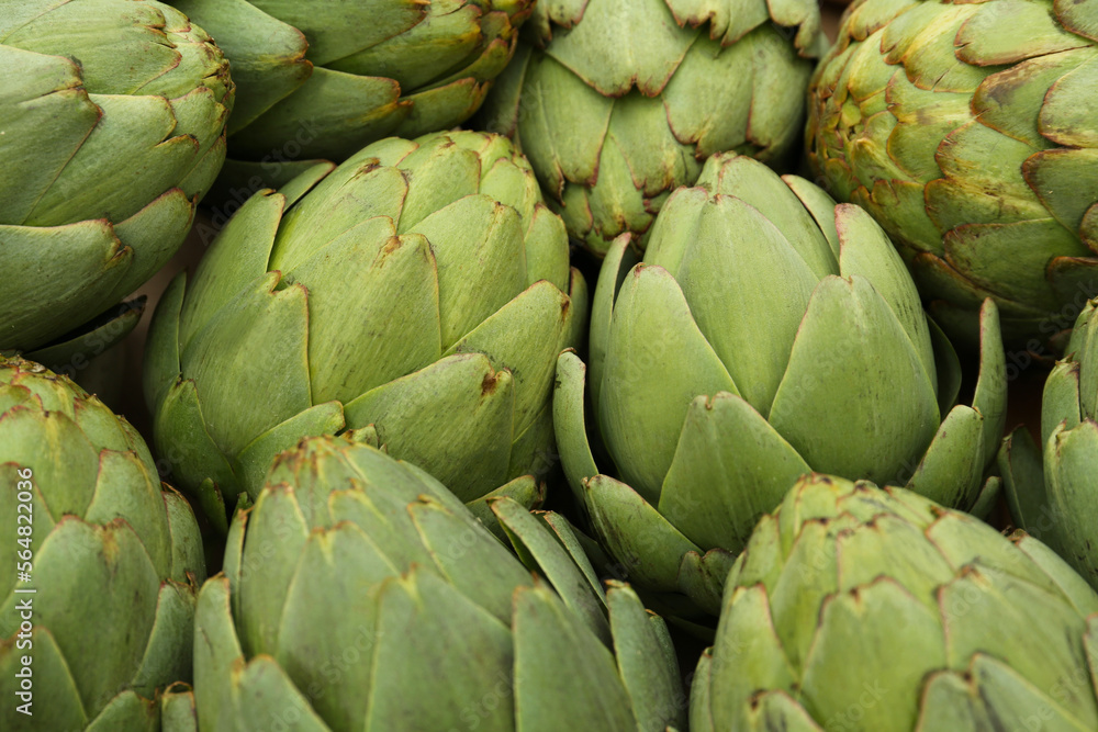 Many fresh raw artichokes as background, closeup Many fresh raw artichokes as background, closeup