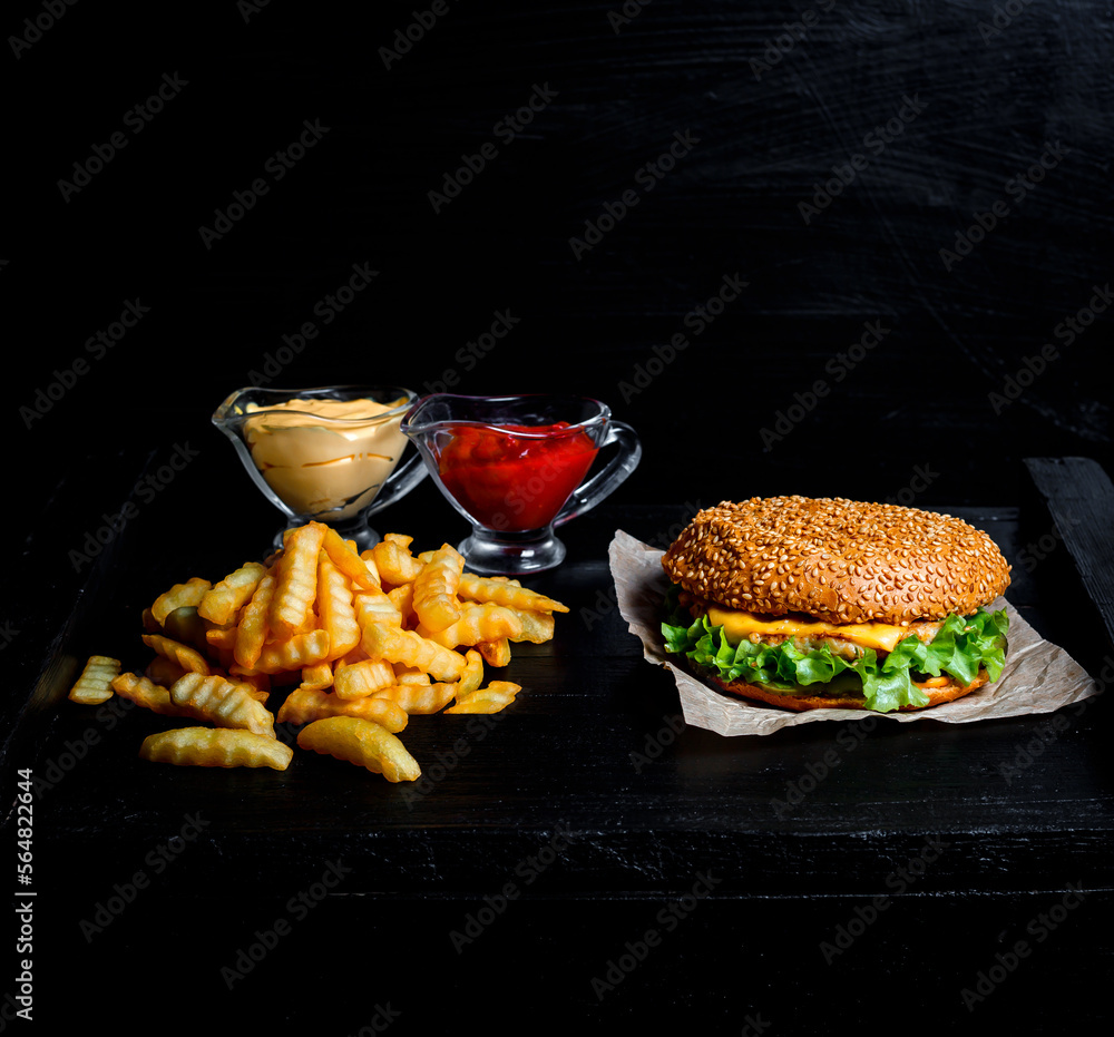 hamburger and white and red sauce and fries