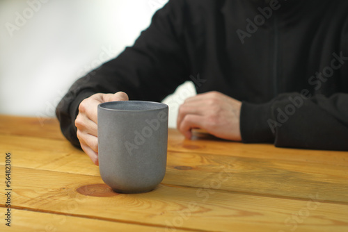 person holding a mug with coffee