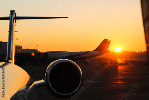 Airplane in airport at sunset