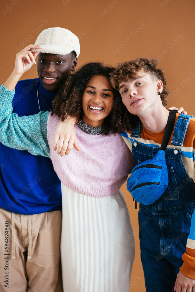 © BONNINSTUDIO/Stocksy - Stylish diverse friends embracing and looking at camera © BONNINSTUDIO/Stocksy - Stylish diverse friends embracing and looking at camera