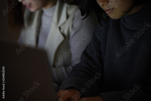 Obraz na płótnie 暗い中でパソコンを使う女性