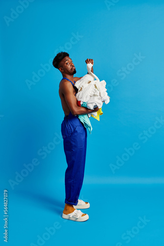 Puzzled black man with dirty clothes