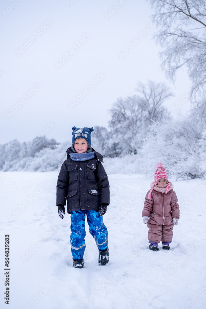 children walking in a snowy landscape children walking in a snowy landscape