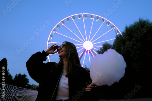 woman in amusement park with ferris wheel
 photo