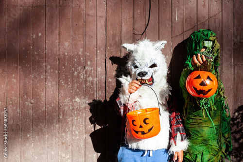 kids with halloween costumes with scary masks photo