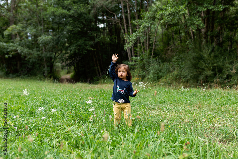 Cute girl walking through the meadow Cute girl walking through the meadow