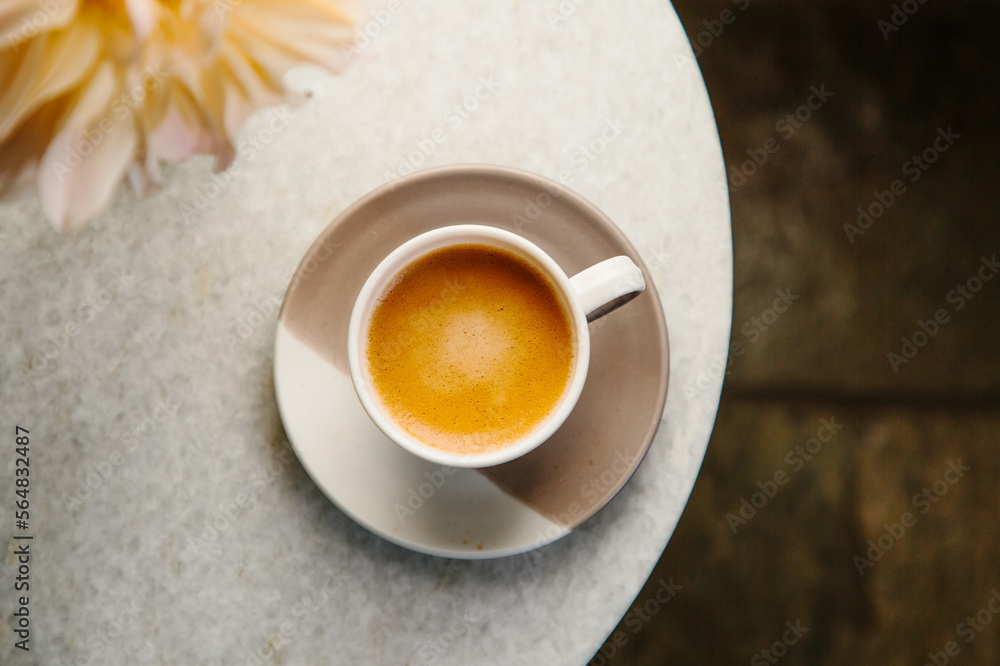 © Helen Rushbrook/Stocksy - Large Dahlia flowers and a cup of espresso. © Helen Rushbrook/Stocksy - Large Dahlia flowers and a cup of espresso.