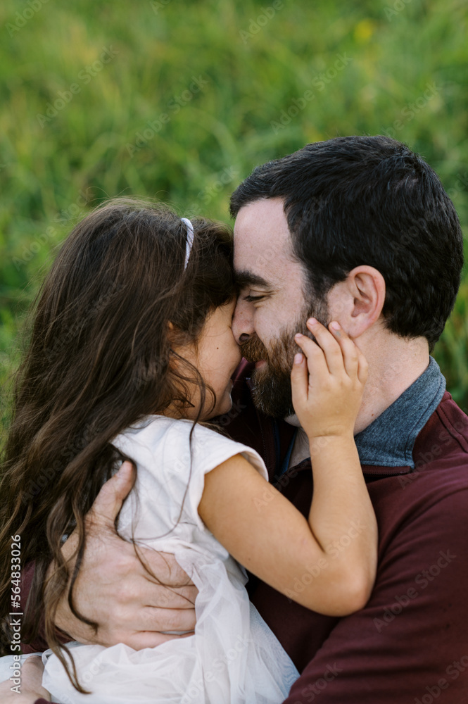 toddler and father playing together in a field toddler and father playing together in a field